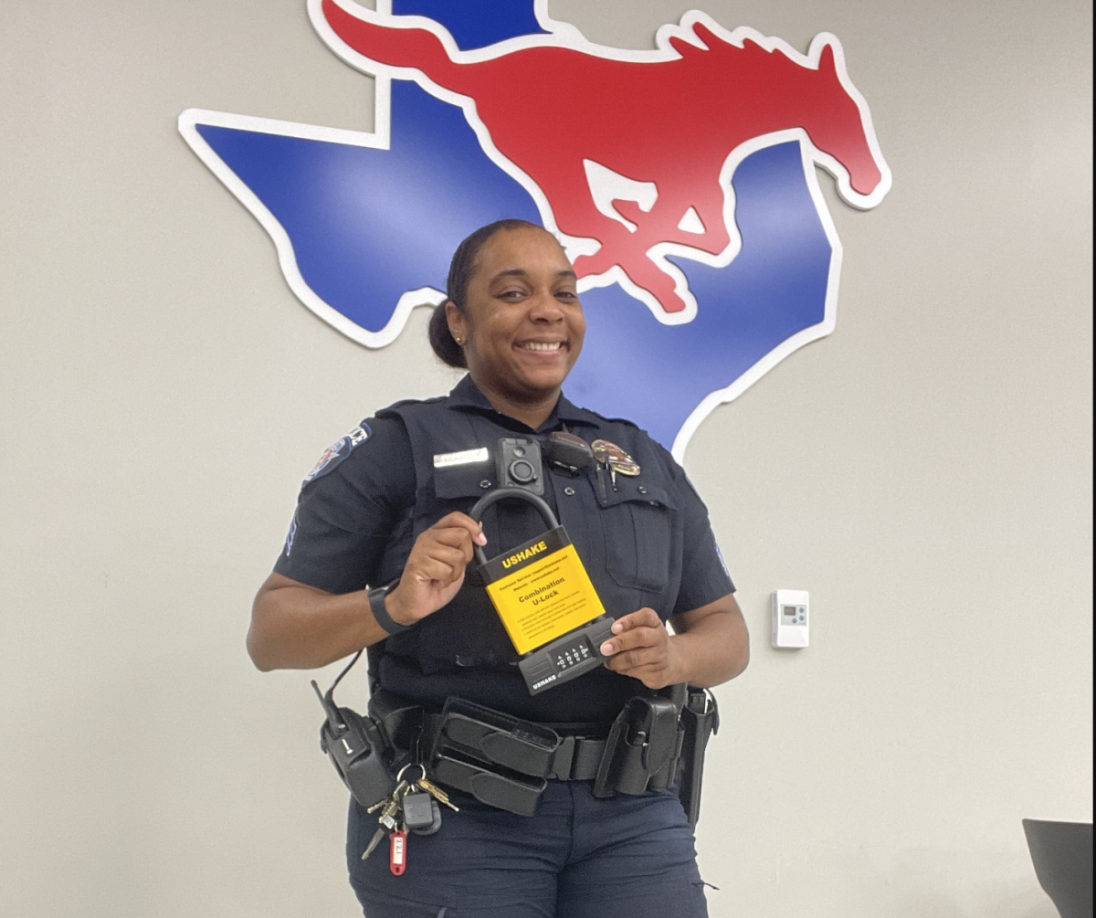 Officer Courtney Morrison holds a lock that's provided by SMU PD to students when they register a bicycle with the department. 